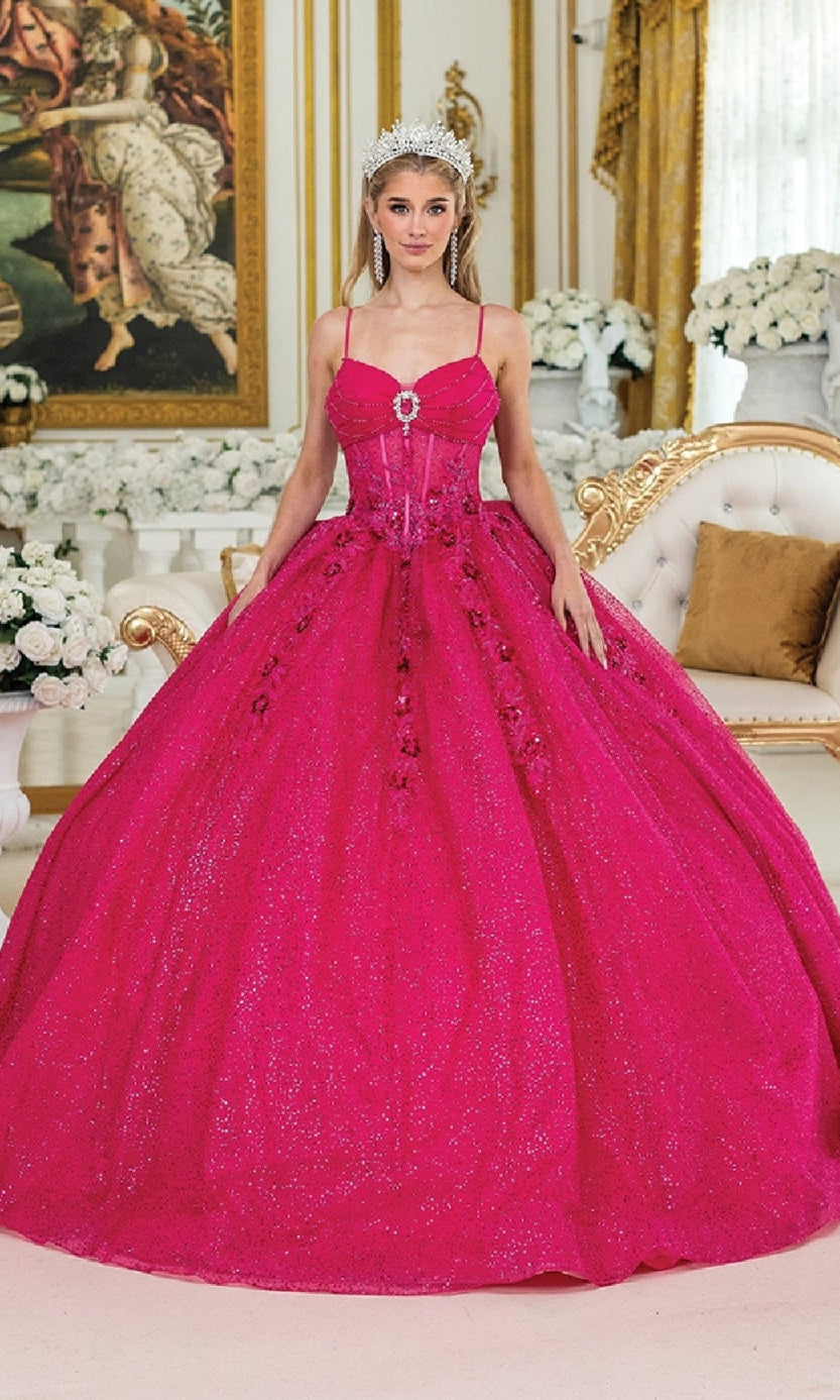 A woman in the Dancing Queen 1958 Long Quinceañera Dress with Bow and a tiara stands in an ornate room decorated with flowers and gold accents.